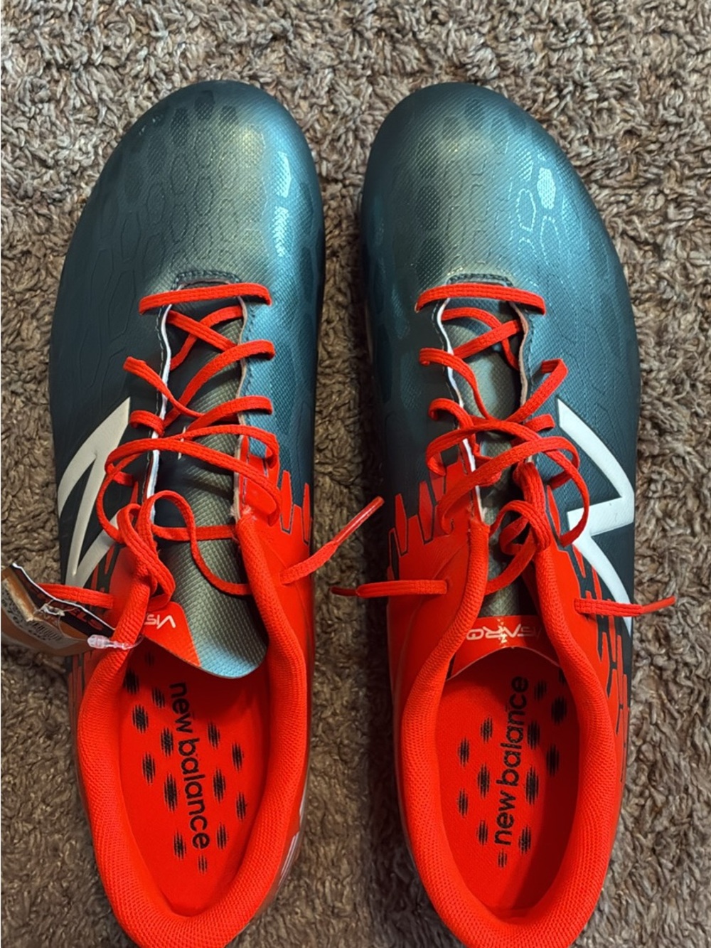 New Balance Teal Soccer Cleats with orange Accents